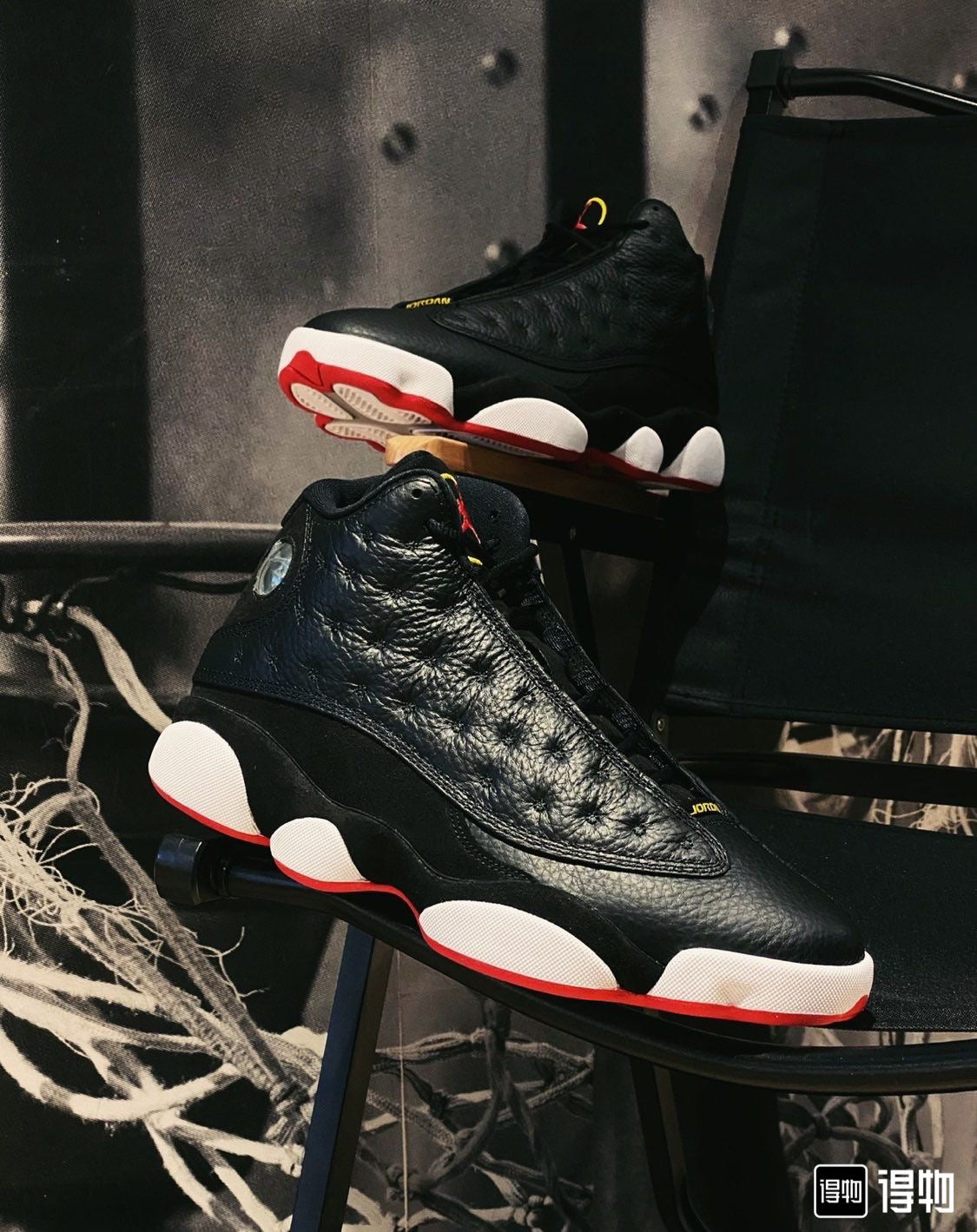 Air Jordan 13 Retro "Playoffs" sneakers in a black, red, and white colorway.