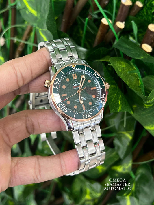 Omega Seamaster Diver 300M in grade 2 titanium and bronze gold with a green dial.